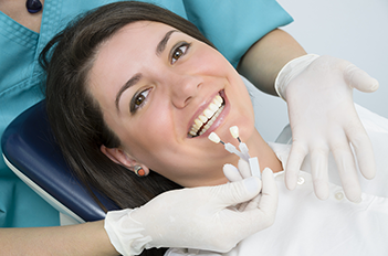 woman smiling in dentist chair getting professional teeth whitening in Chelsea, NY and New York, NY